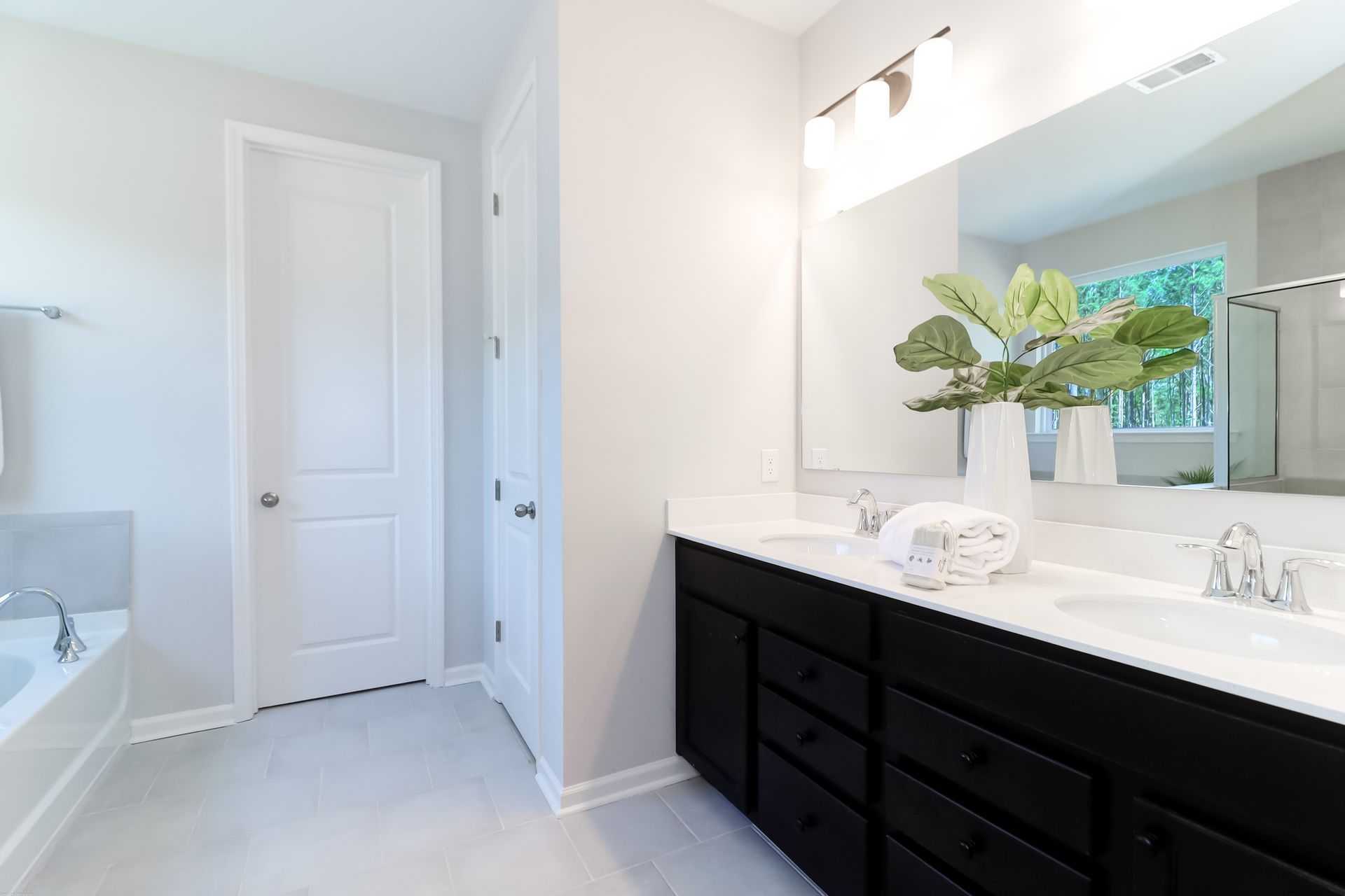 A bathroom with two sinks and a large mirror.