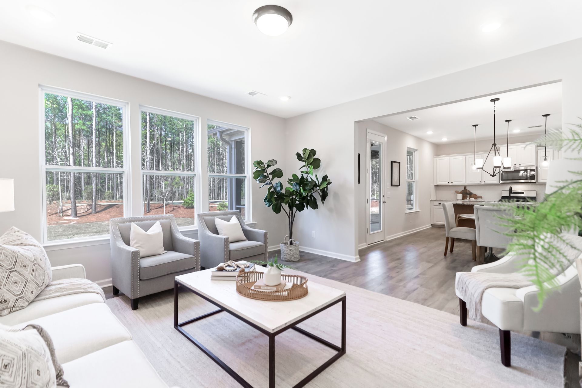 A living room with a couch , chairs , and a coffee table.