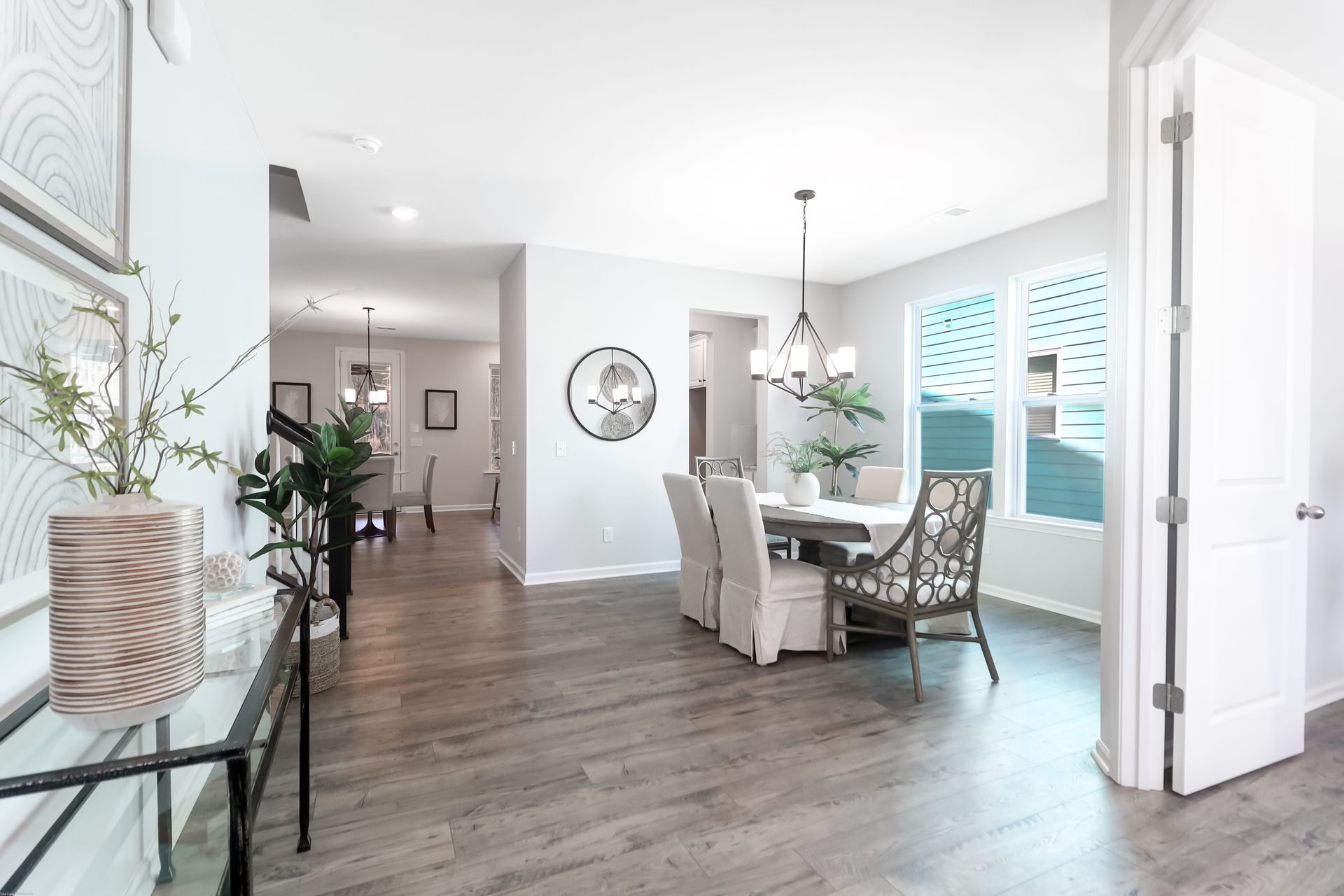 A dining room with a table and chairs in a house.
