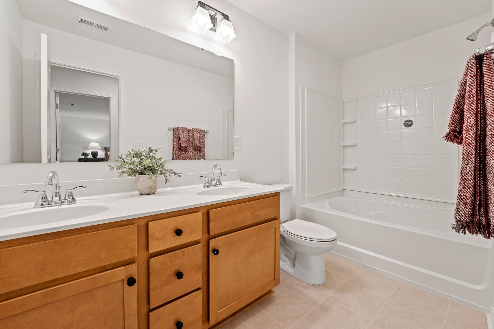 A bathroom with two sinks , a toilet , and a bathtub.