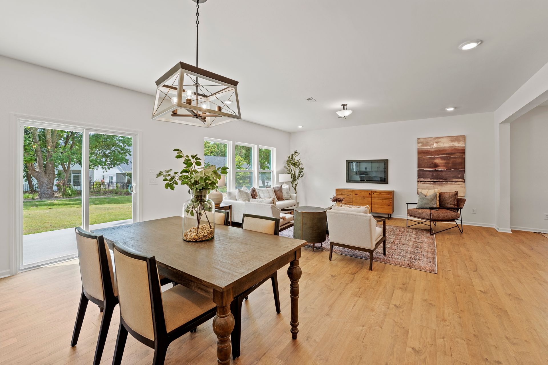 There is a dining table and chairs in the middle of the room.
