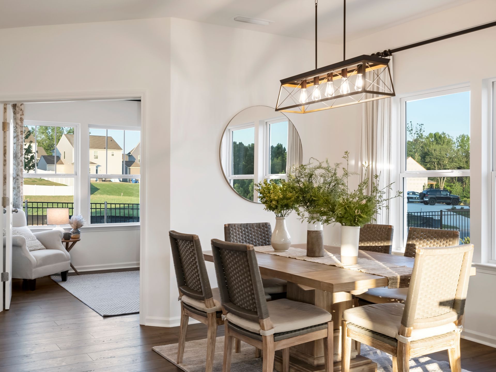 A dining room with a table and chairs and a chandelier.