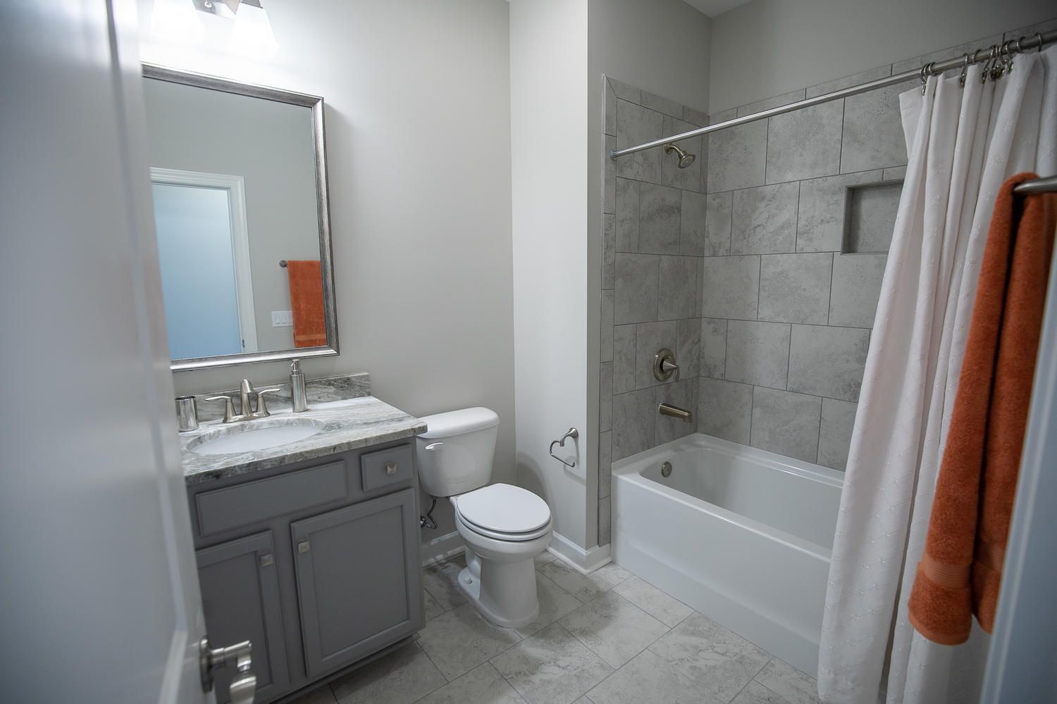 A bathroom with a toilet , sink , shower and bathtub.
