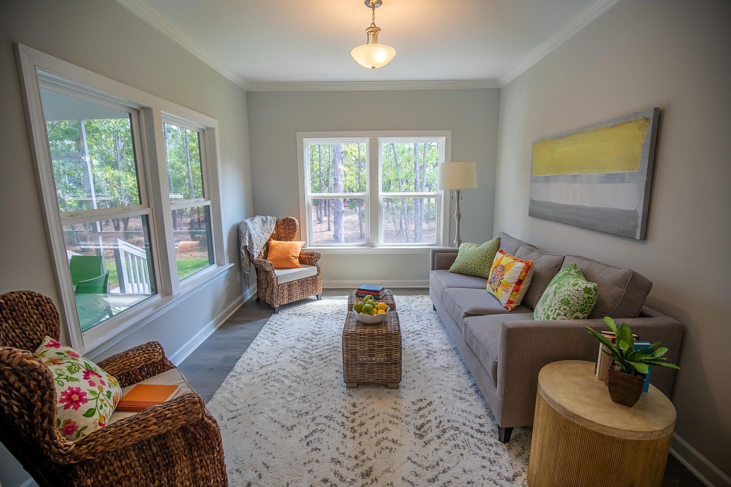 A living room with a couch , chairs , and a coffee table.