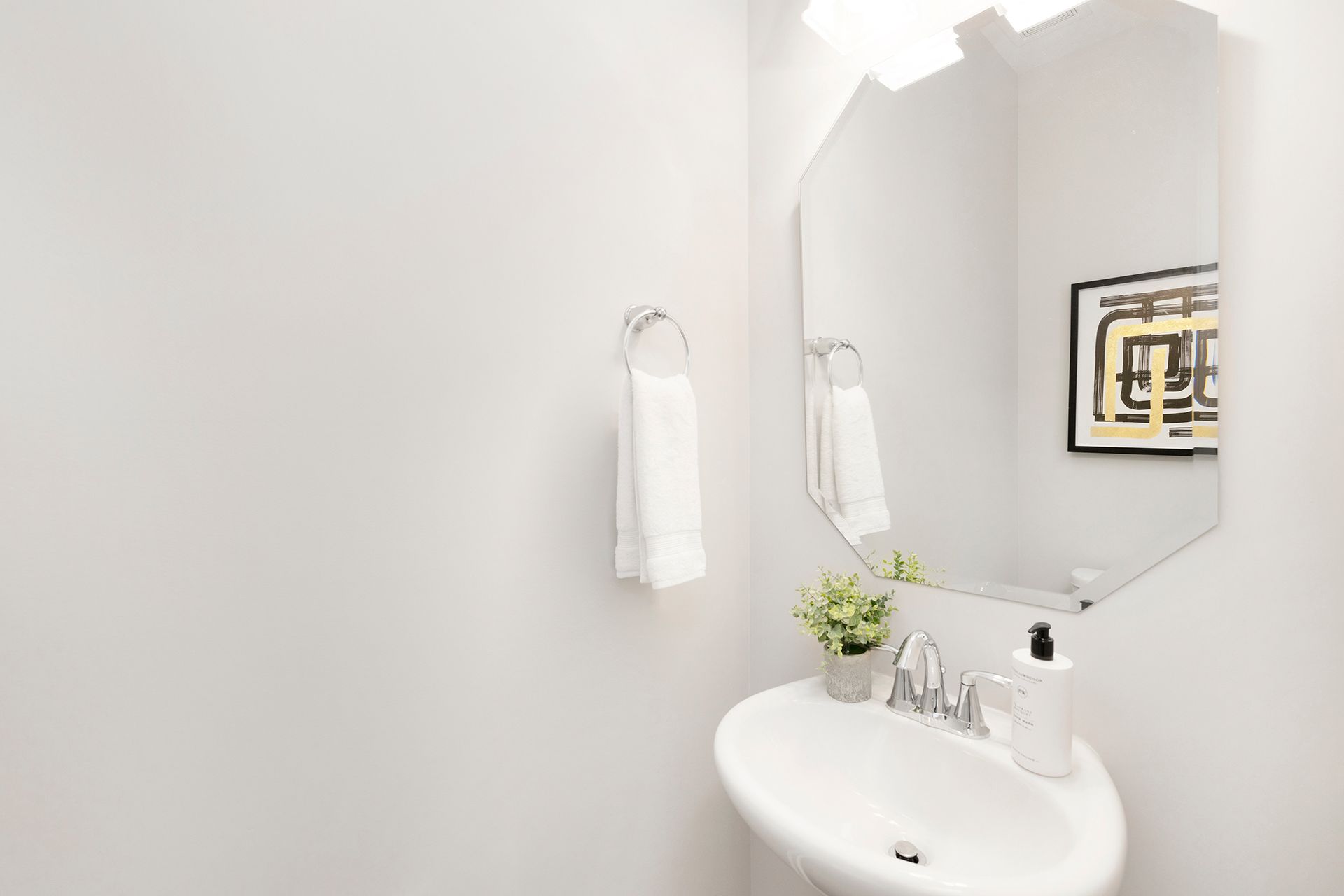 A bathroom with a sink and a mirror.