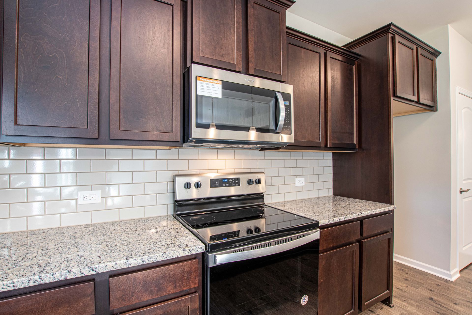 A kitchen with stainless steel appliances and granite counter tops.