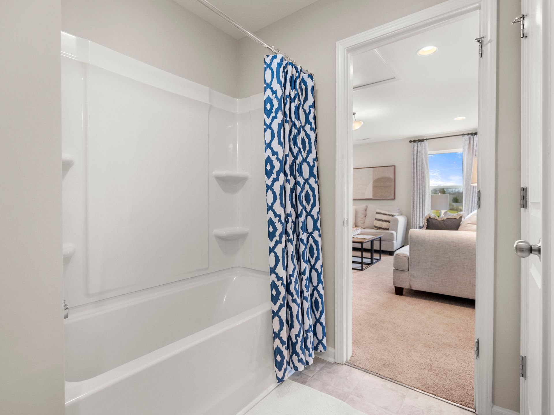 A bathroom with a bathtub and a shower curtain.