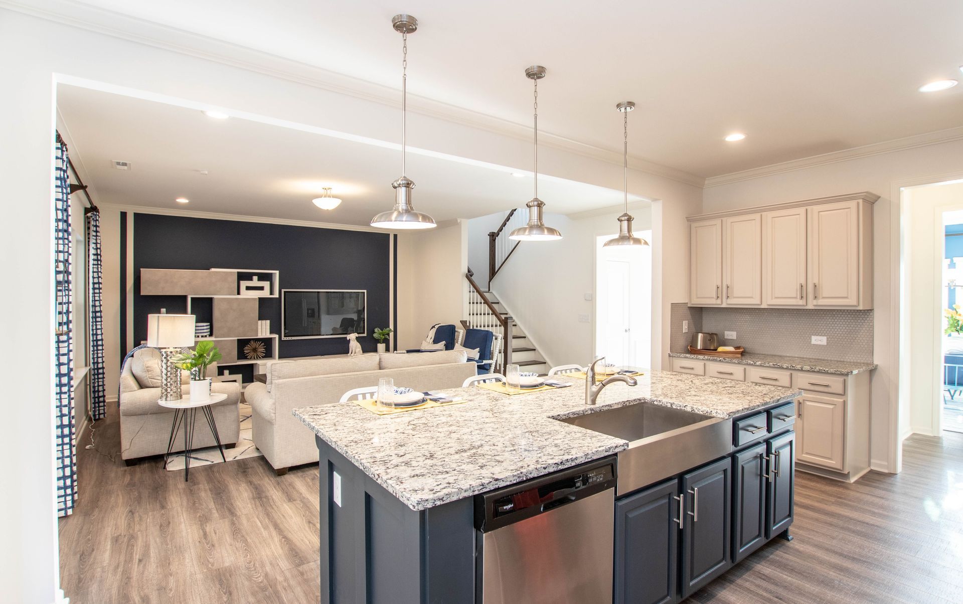 A kitchen with granite counter tops , stainless steel appliances , and a large island.