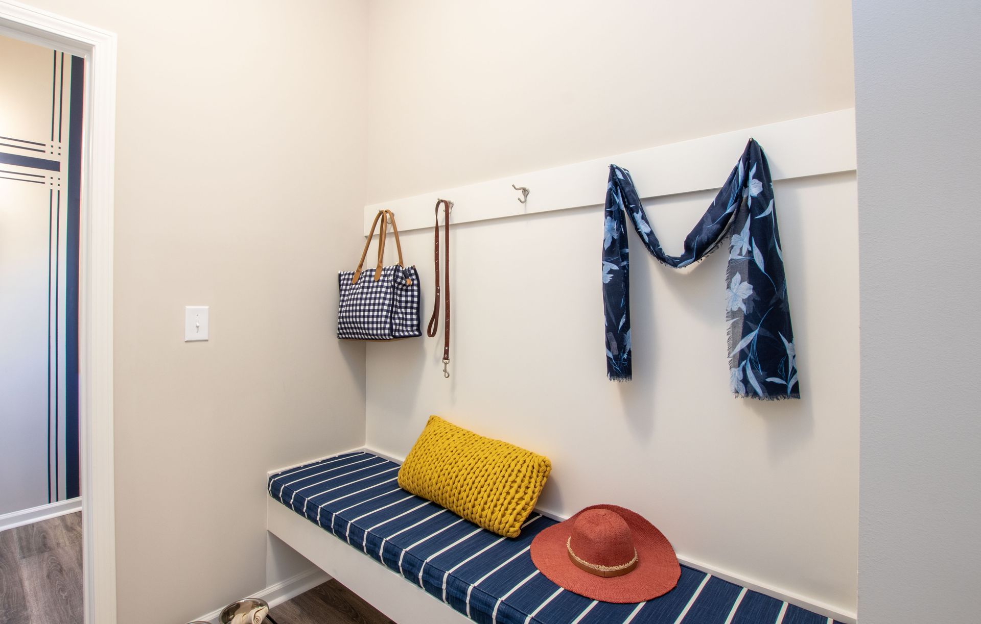 There is a bench with a hat and a bag on it.