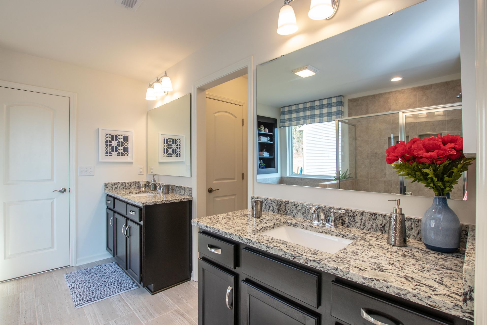 A bathroom with two sinks and a large mirror.