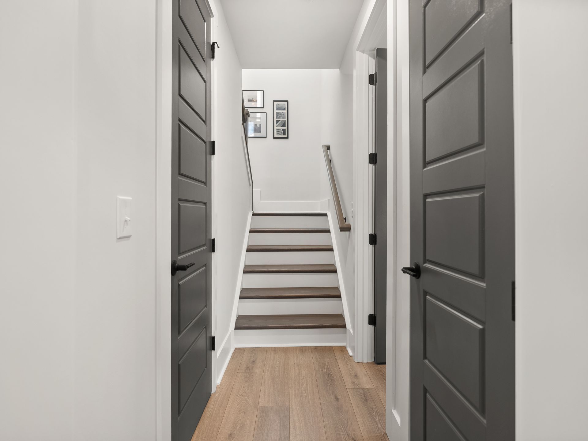 A hallway with stairs leading up to the second floor of a house.