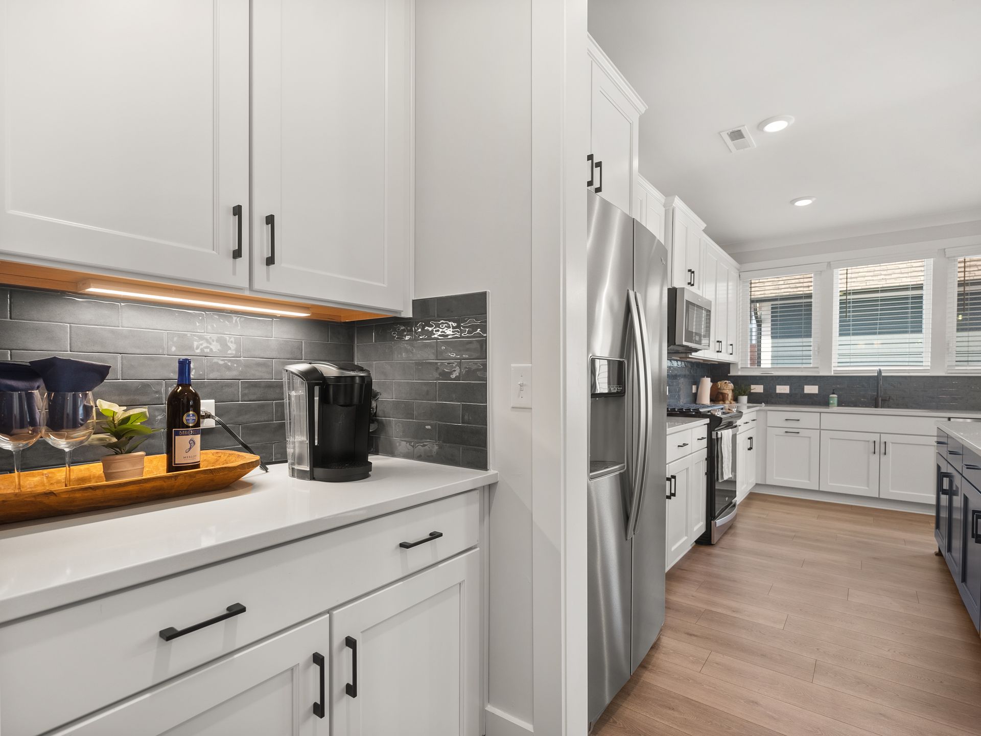 A kitchen with white cabinets and stainless steel appliances.