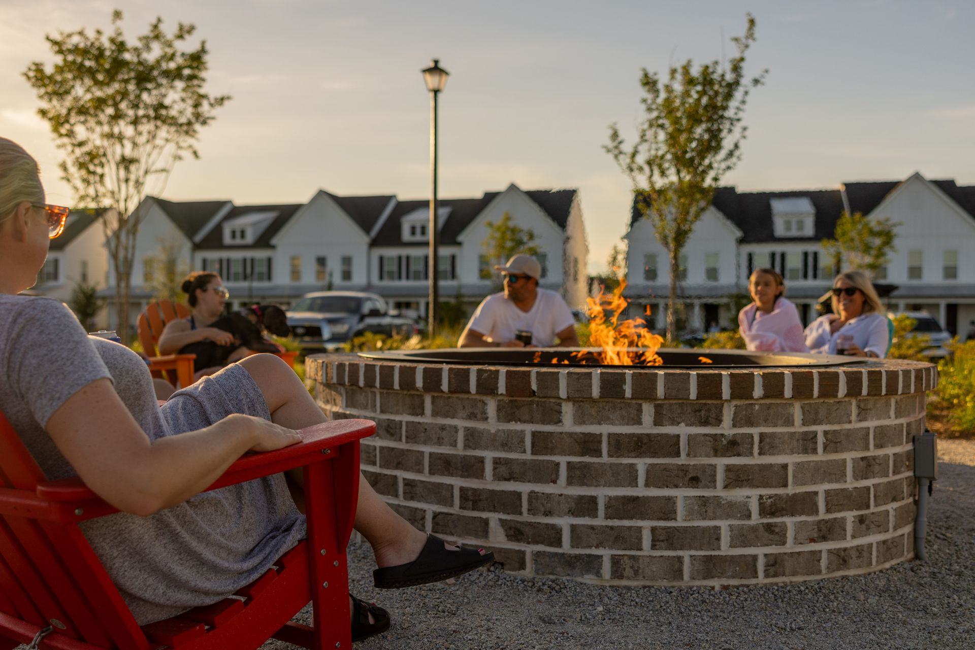 A group of people are sitting around a fire pit.