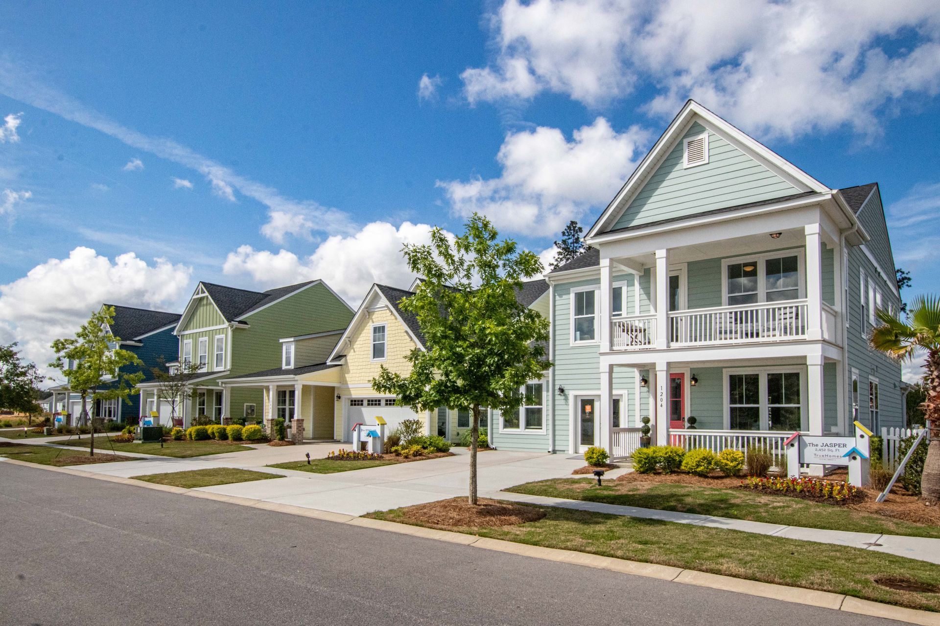A row of houses in a residential neighborhood on a sunny day.