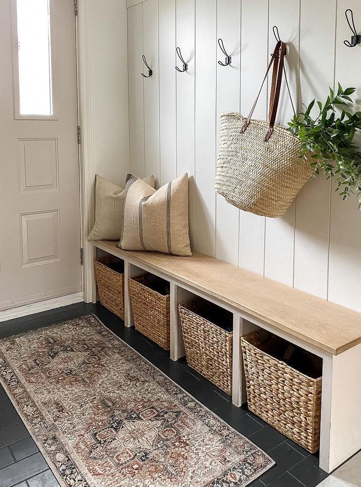 A hallway with a bench and baskets in it