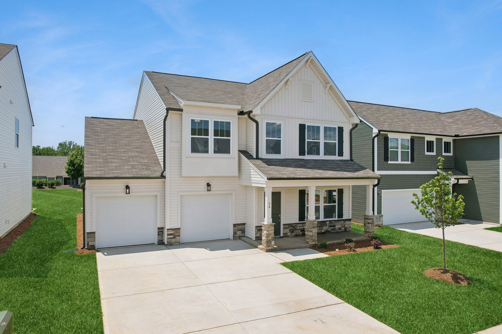 A large house with a lot of windows and a driveway in front of it.