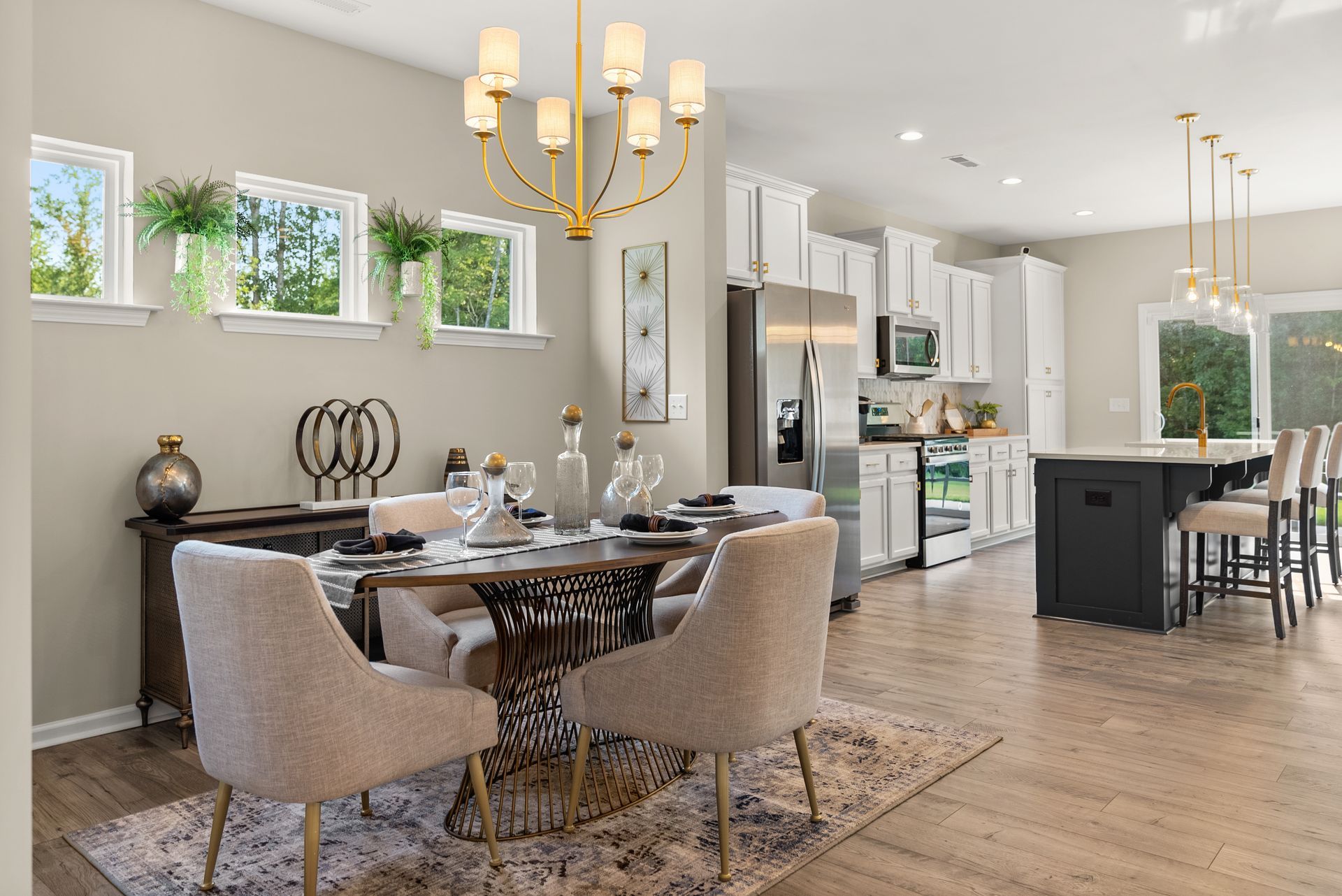 A dining room with a table and chairs and a chandelier.