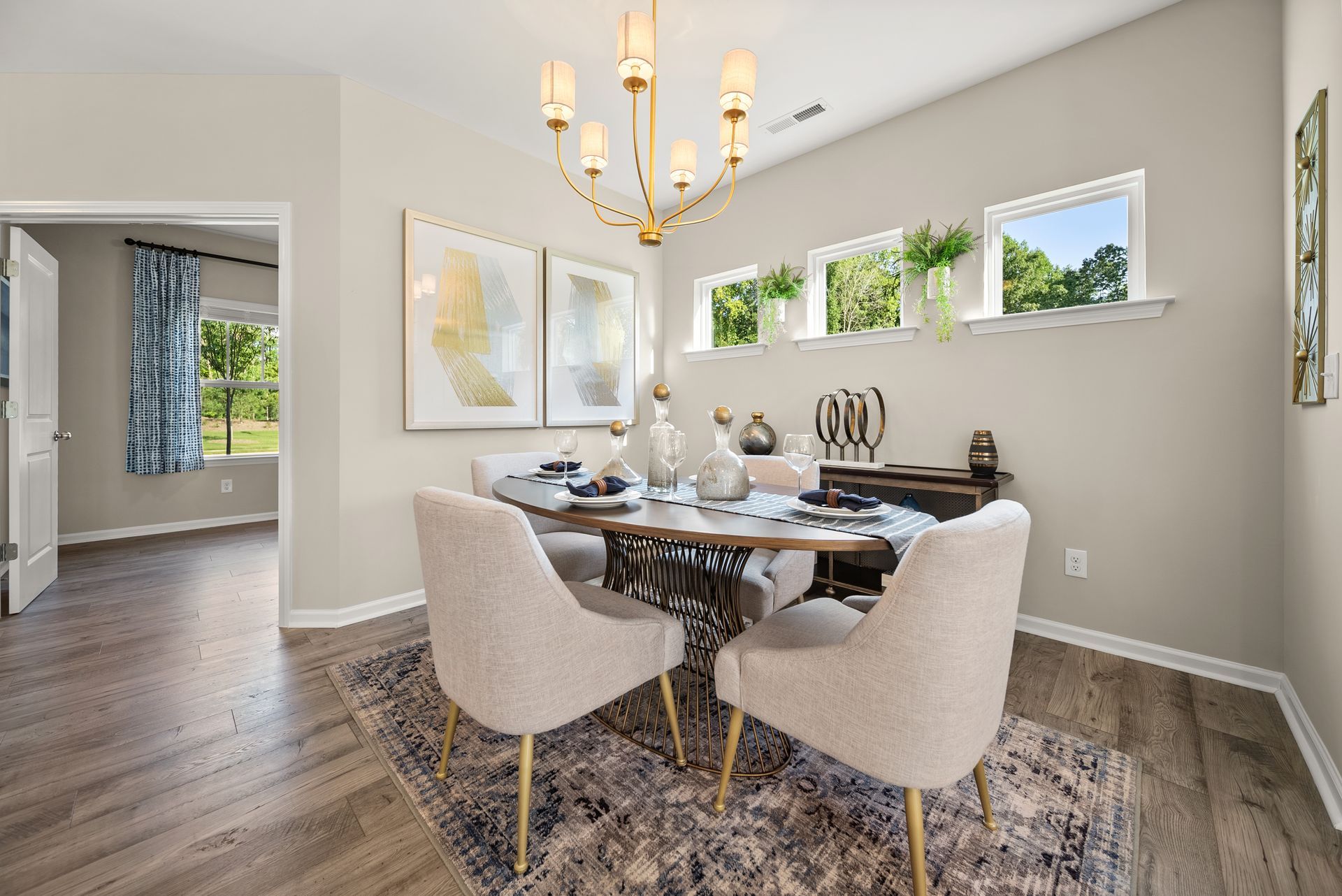 A dining room with a table and chairs and a chandelier.