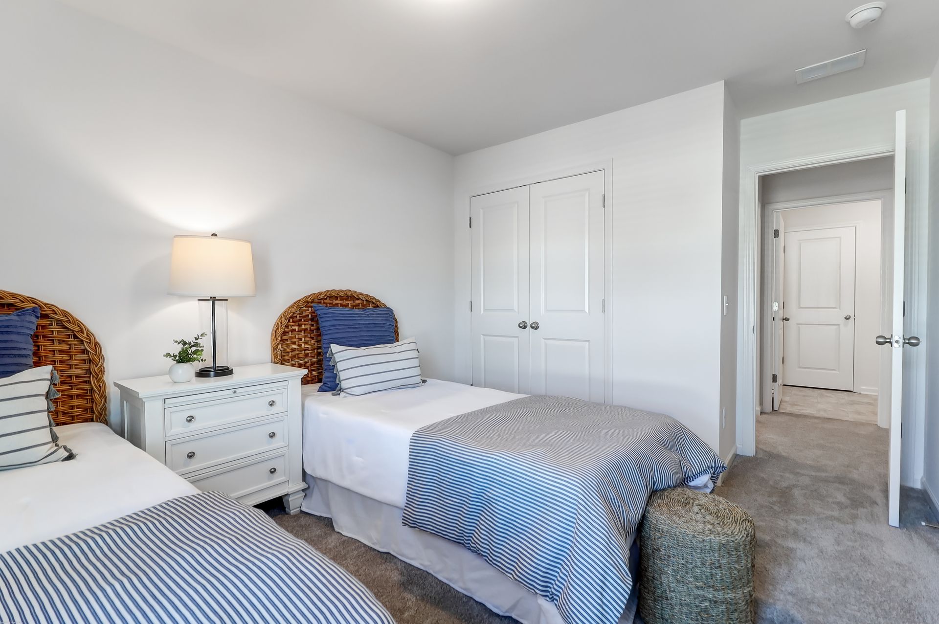 A bedroom with two twin beds and a dresser.
