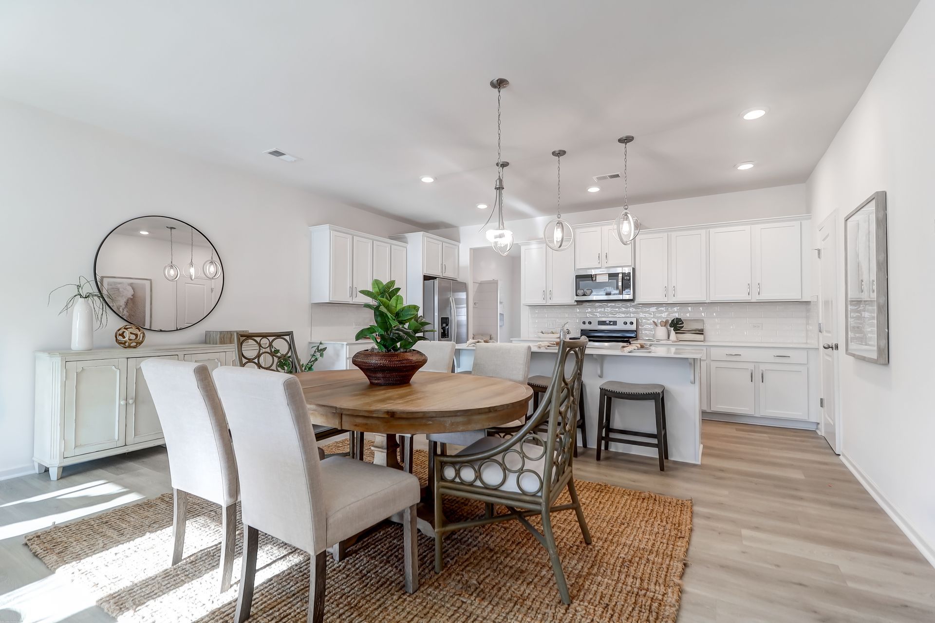 There is a dining room table and chairs in the middle of the room.