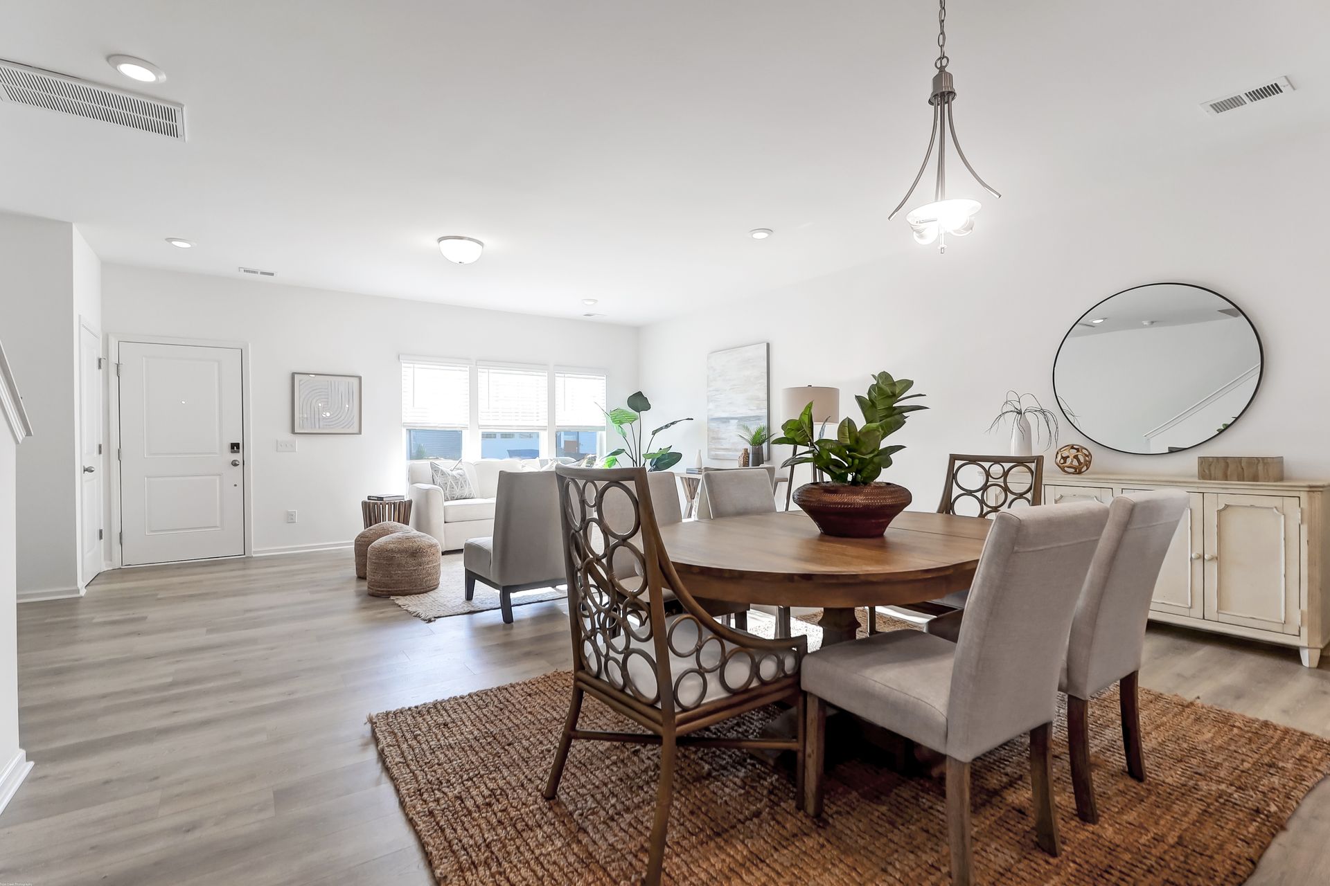 A dining room with a round table and chairs in a house.