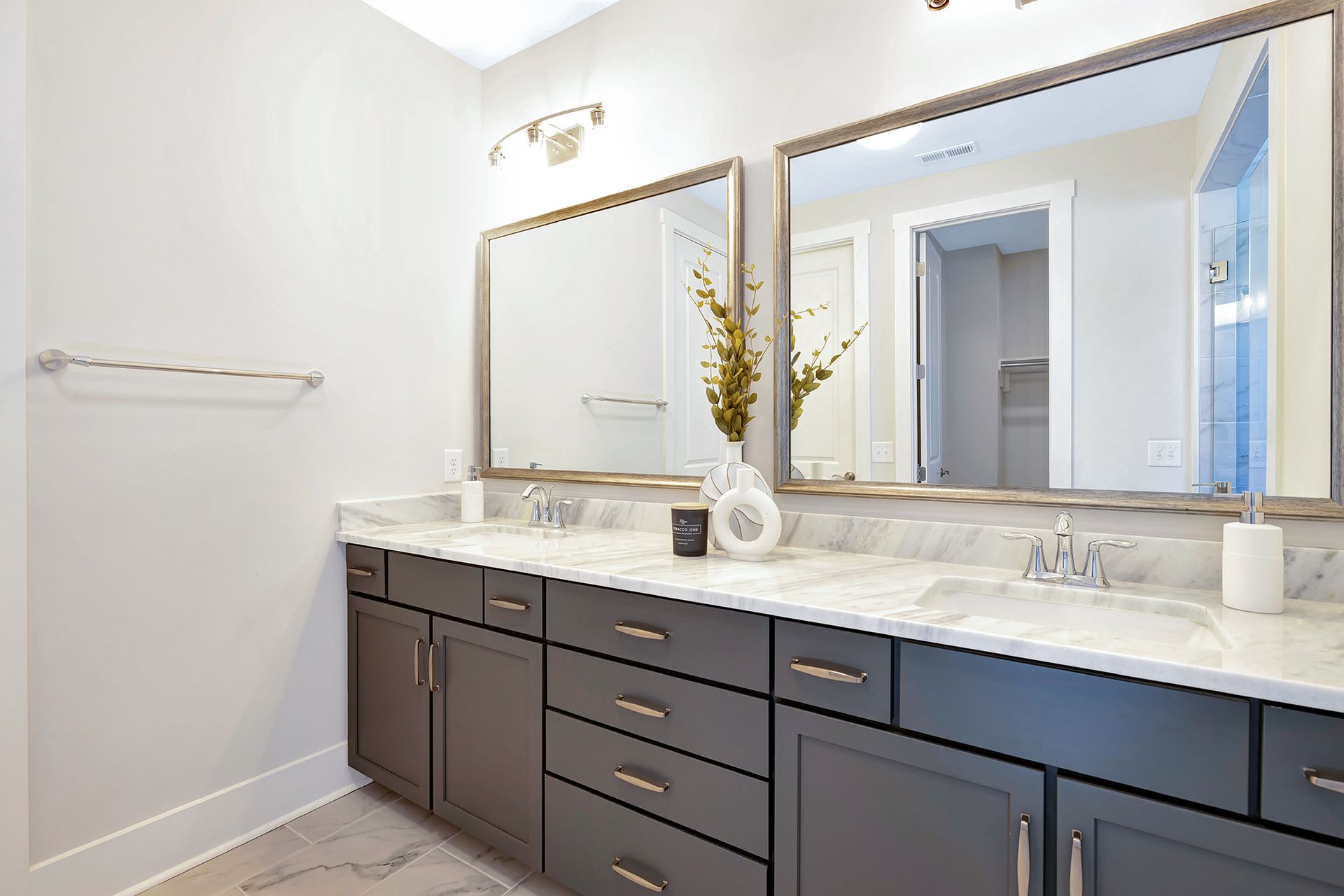 A bathroom with two sinks and two mirrors.