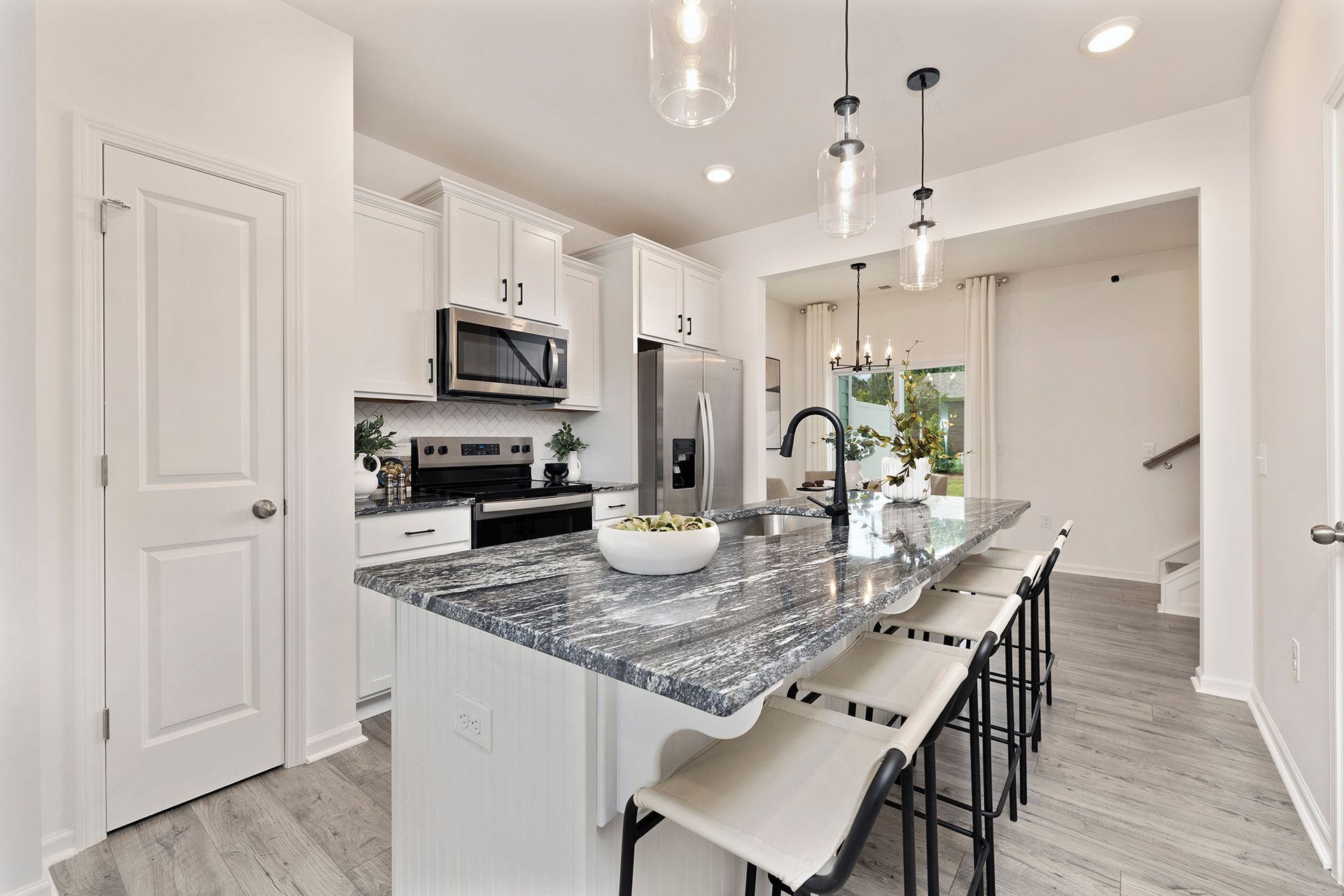 A kitchen with a large island and stools