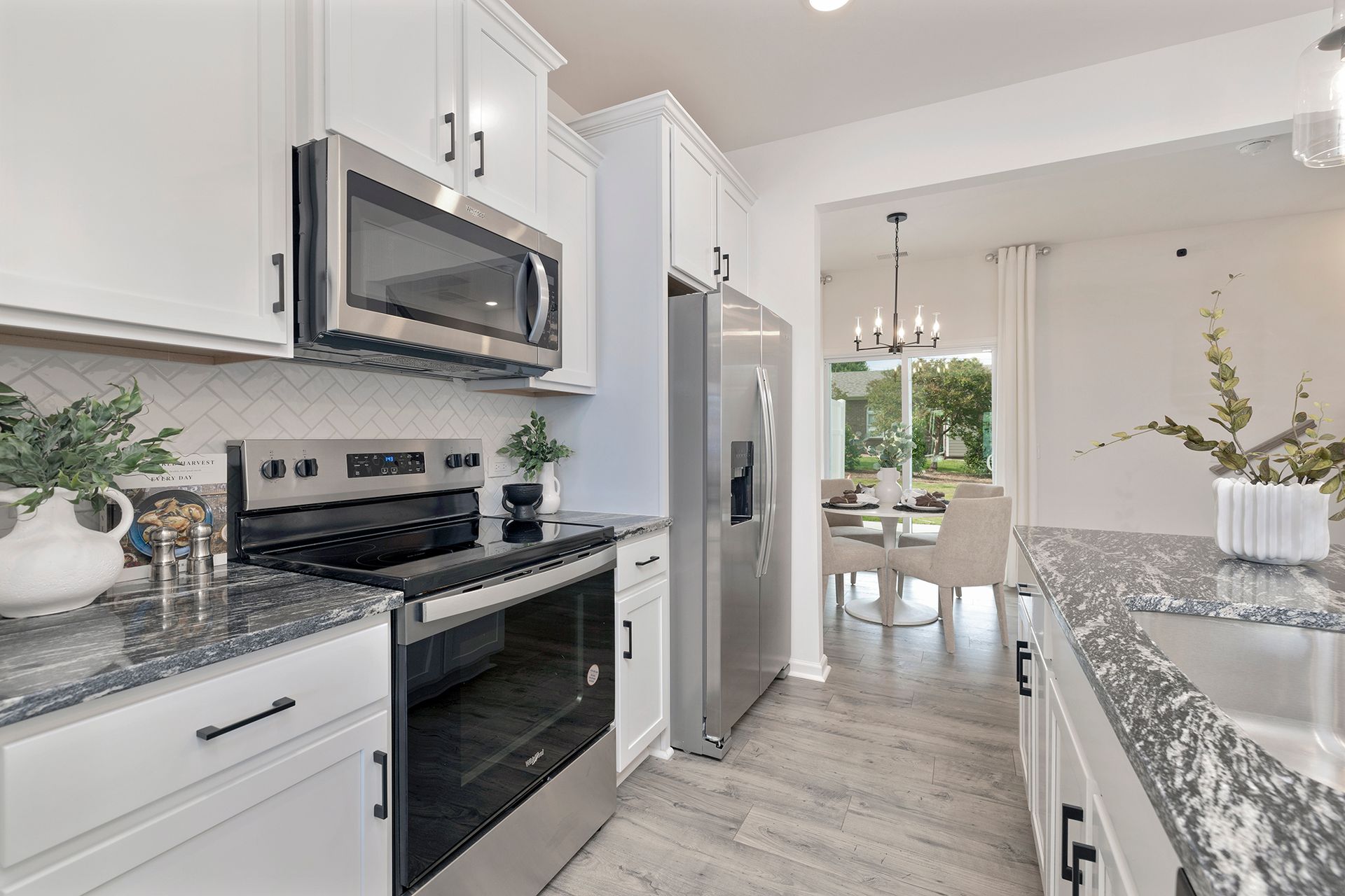 A kitchen with stainless steel appliances and granite counter tops.
