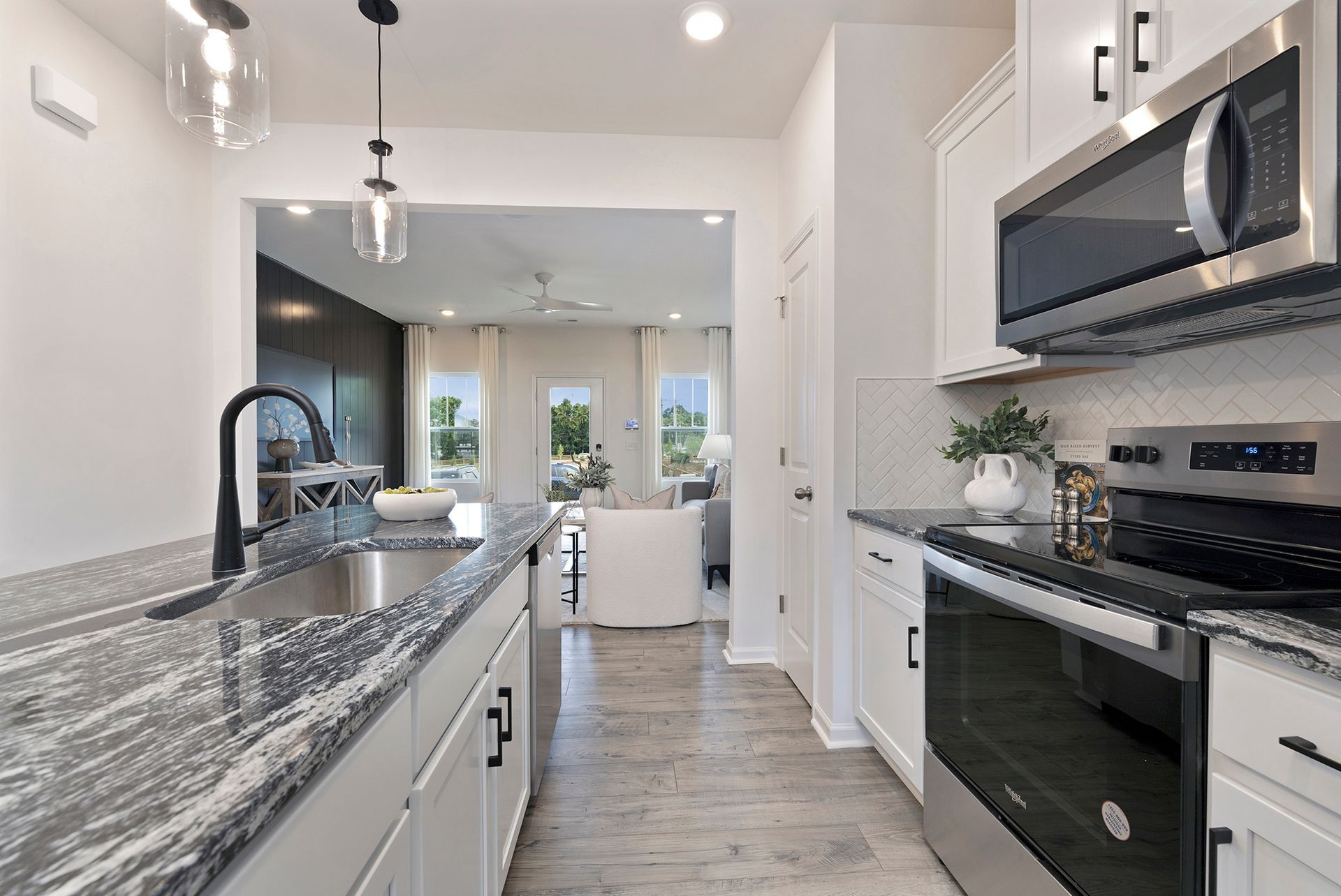A kitchen with granite counter tops and stainless steel appliances