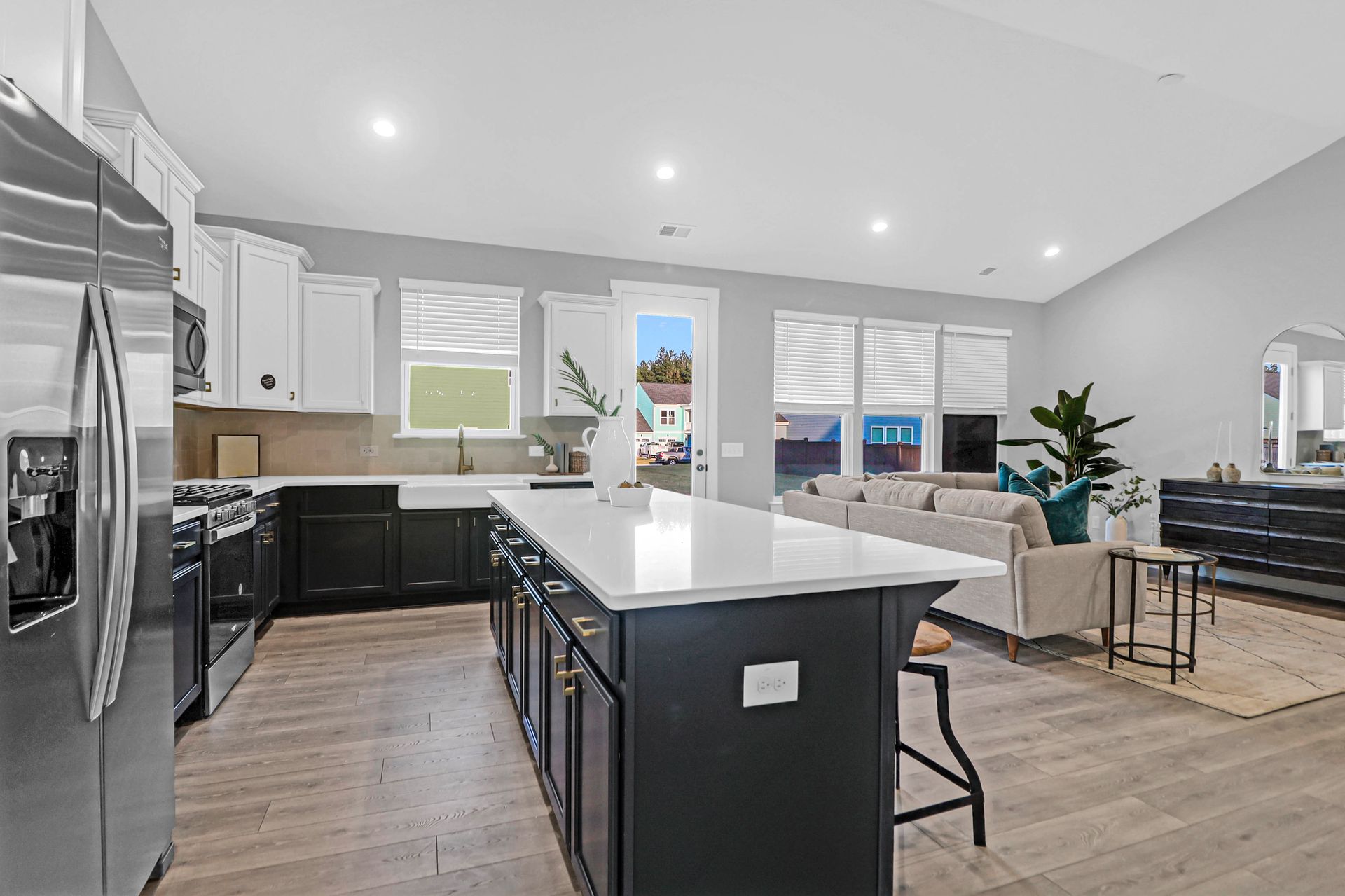 A kitchen with stainless steel appliances and a large island in the middle of the room.
