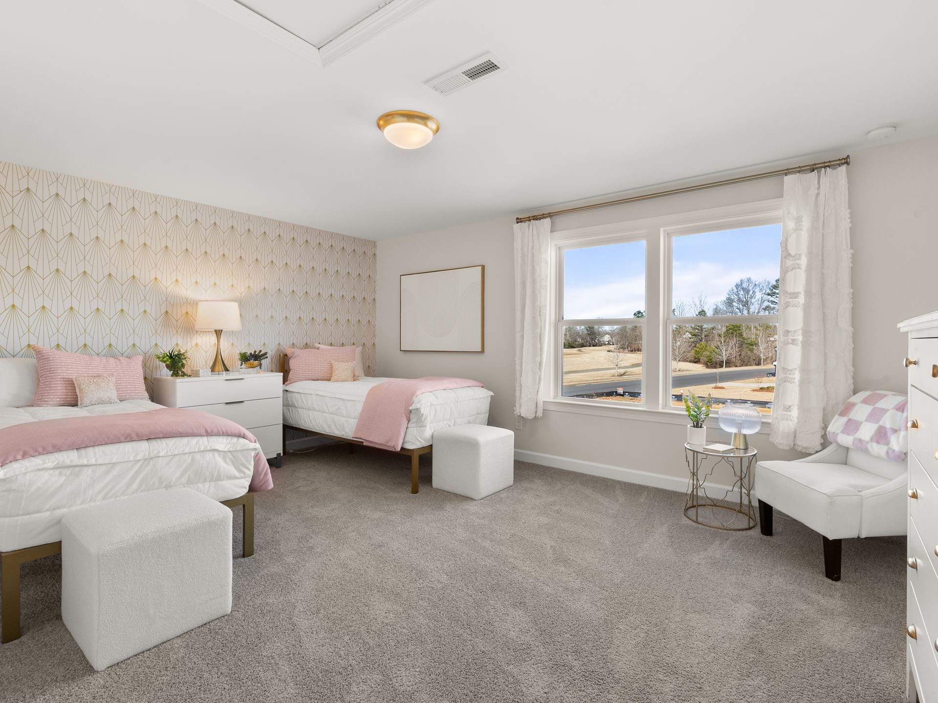 A bedroom with two beds , a dresser , a chair and a window.