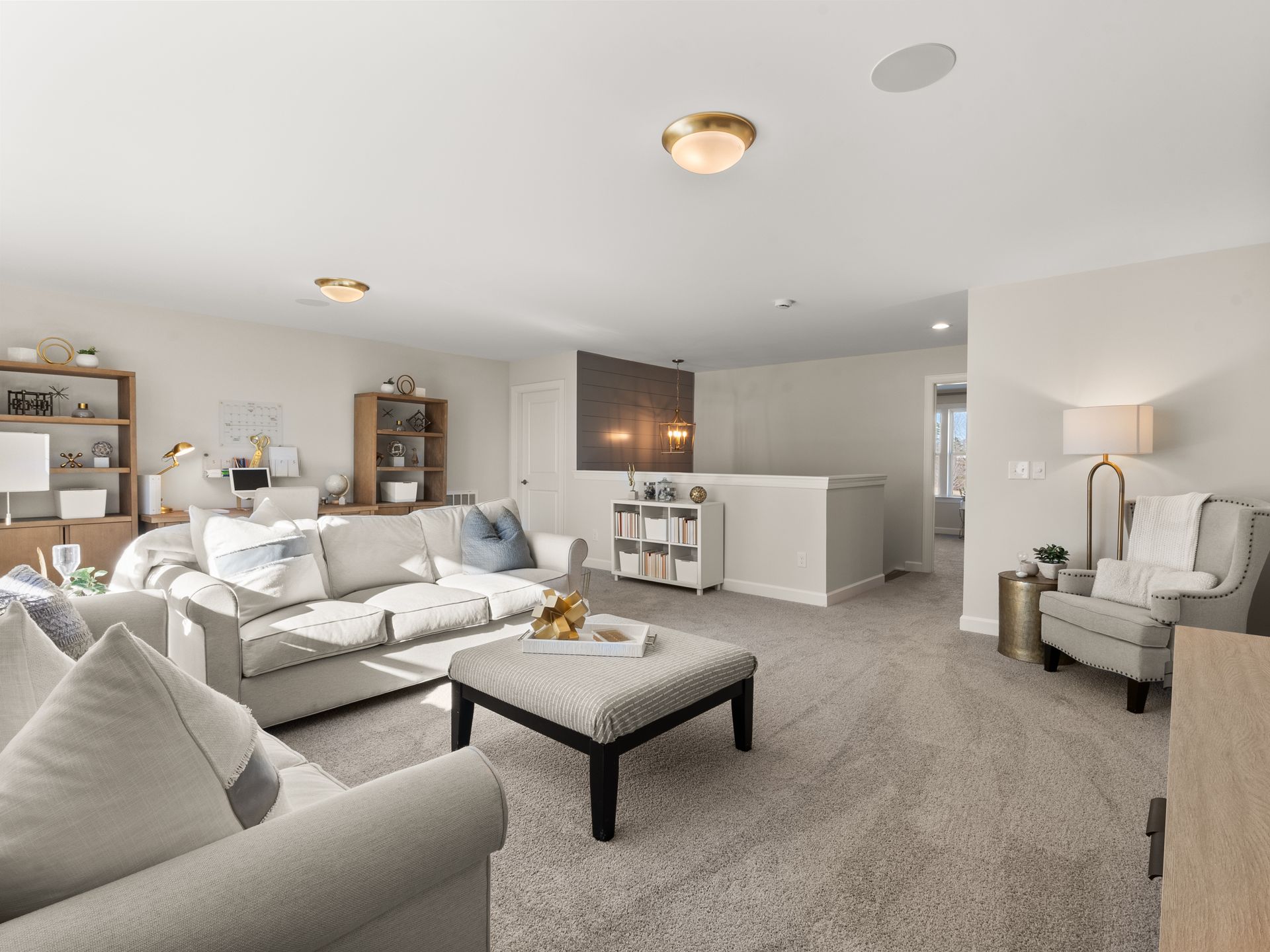 A living room with a couch , chairs , and a coffee table.
