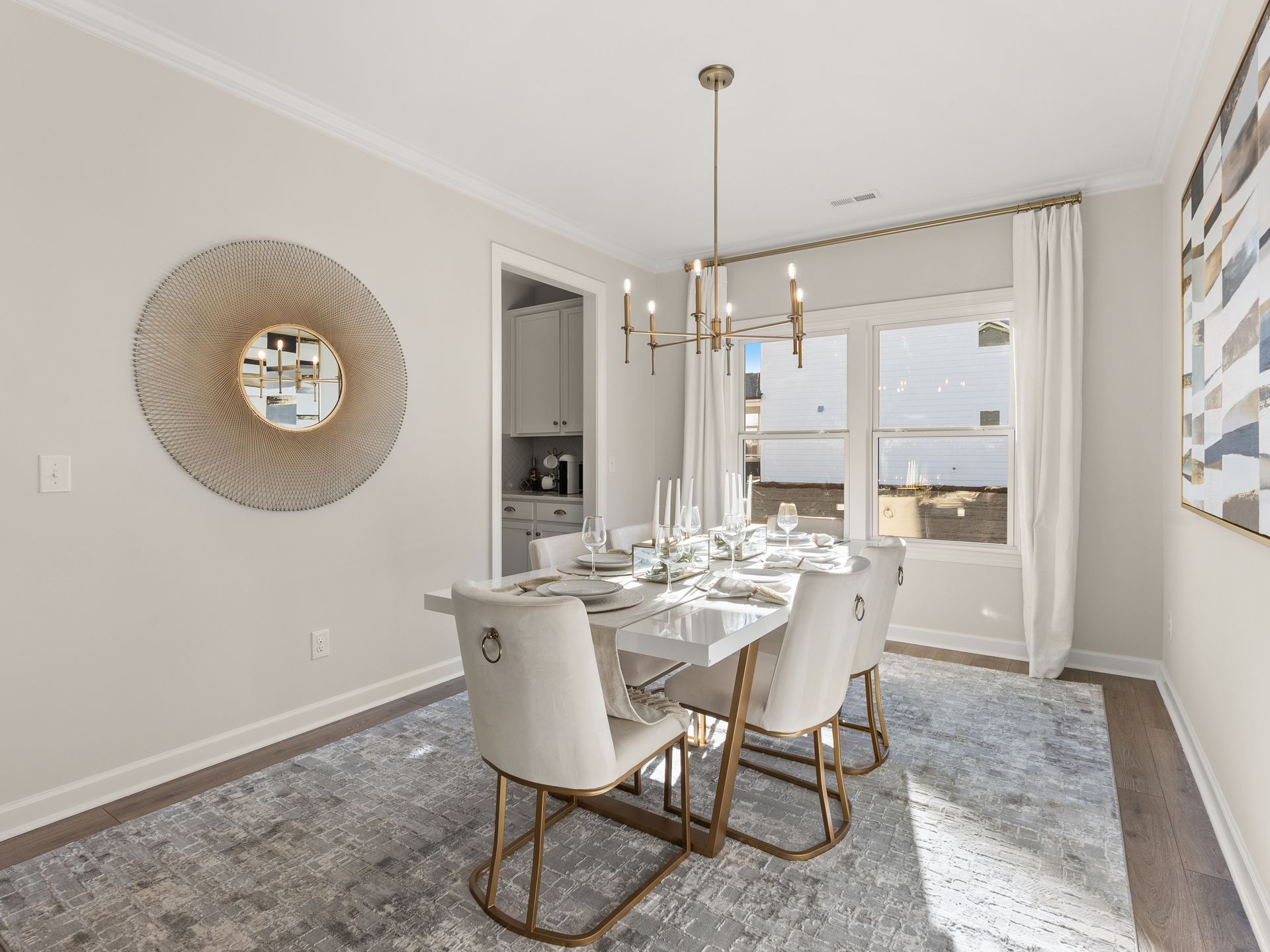 A dining room with a table and chairs and a chandelier.