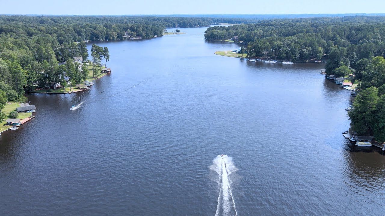 An aerial view of a large body of water surrounded by trees.