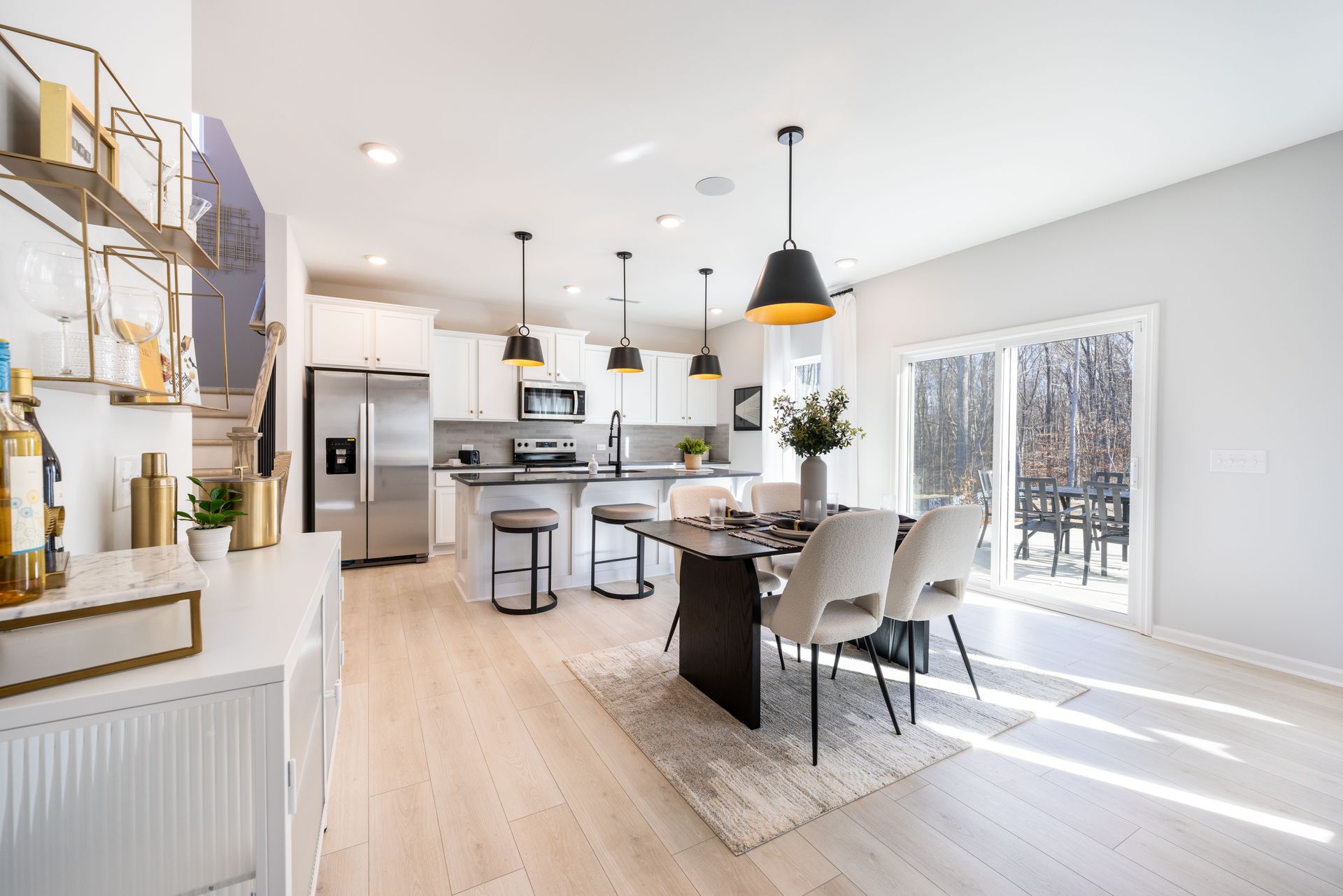 A kitchen and dining room in a house with a table and chairs.