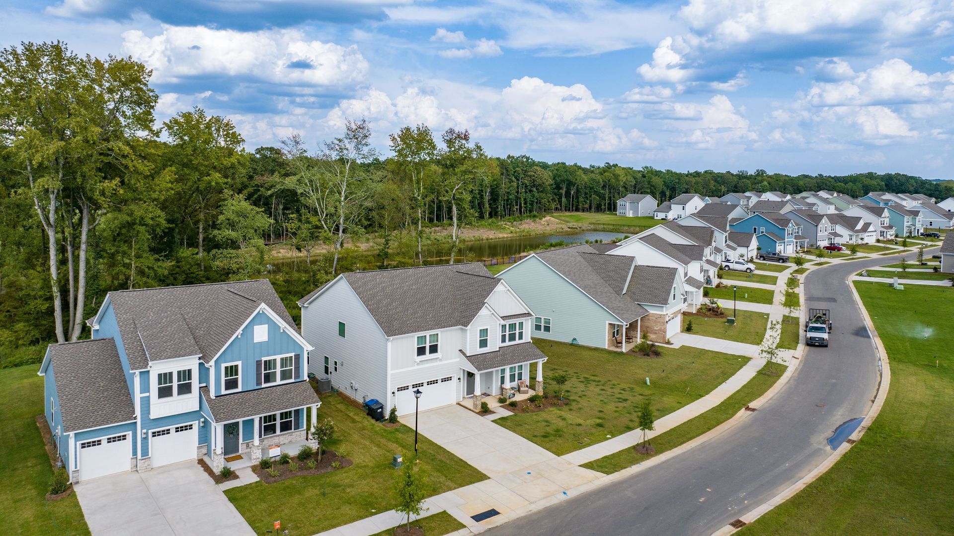 An aerial view of a residential neighborhood with lots of houses and trees.