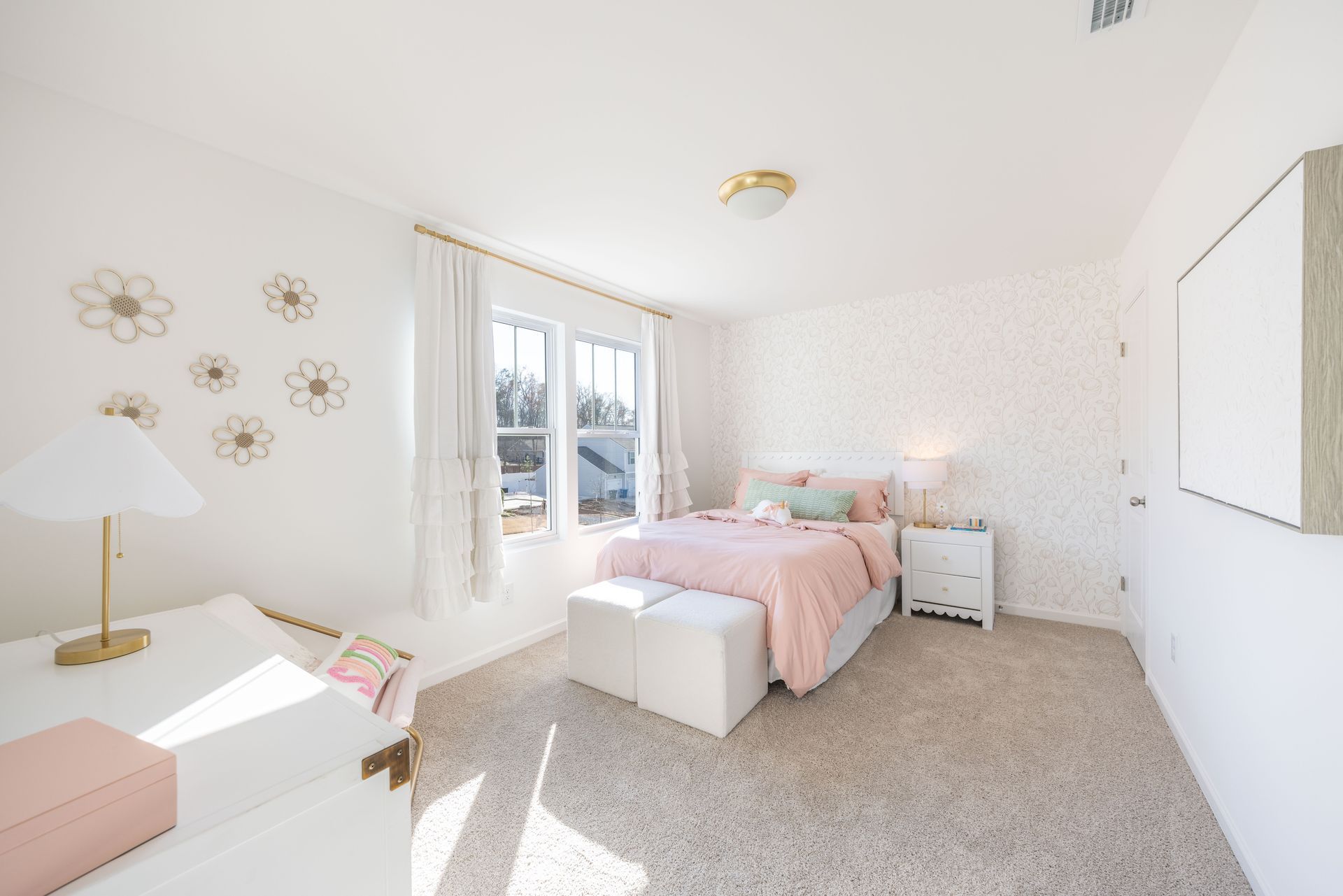 A bedroom with a bed , dresser , nightstand and window.