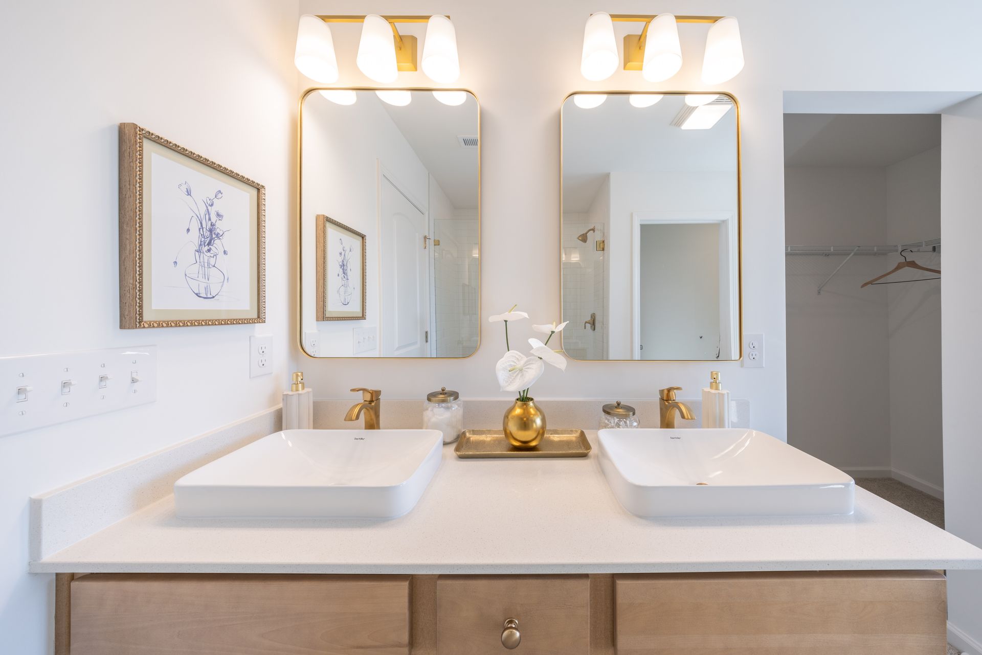 A bathroom with two sinks and two mirrors.
