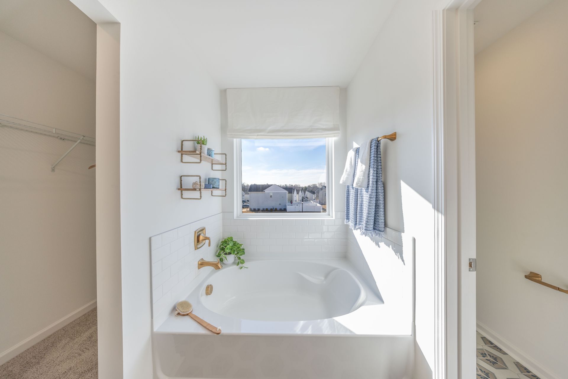 A bathroom with a bathtub and a window.