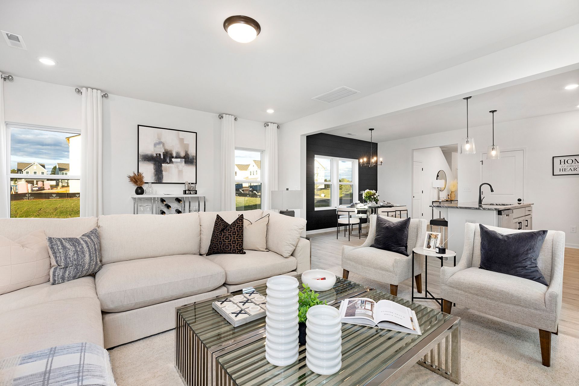 A living room with a couch , chairs , and a coffee table.