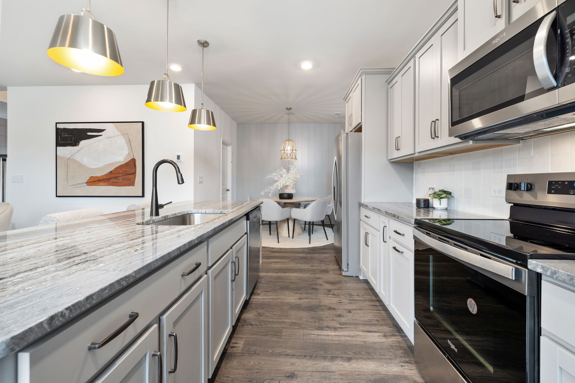 A kitchen with stainless steel appliances and granite counter tops.