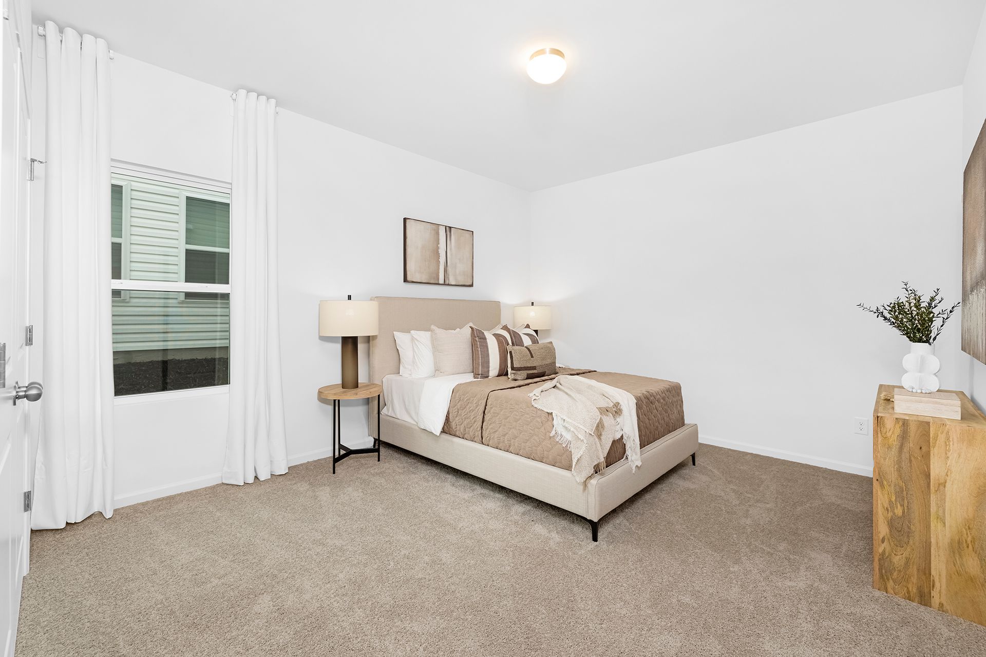 A bedroom with a bed , nightstand , and window.