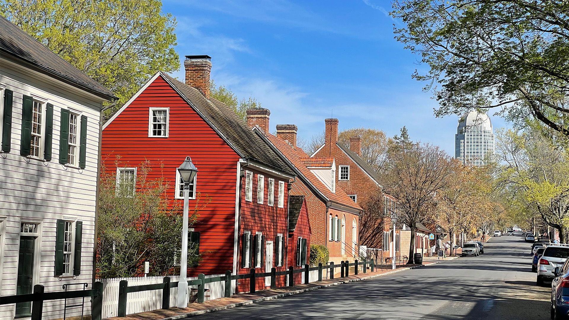 A row of red and white houses on a city street.