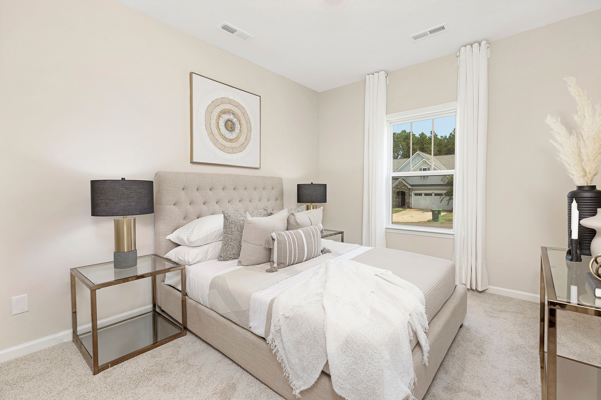 A bedroom with a bed , nightstand , lamps and a window.