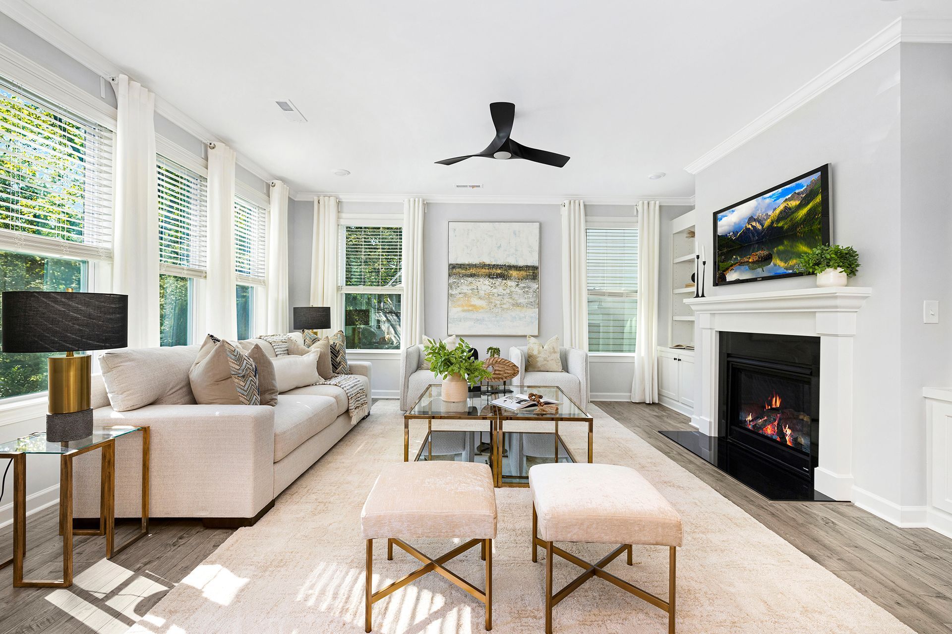 A living room with a fireplace and a ceiling fan.