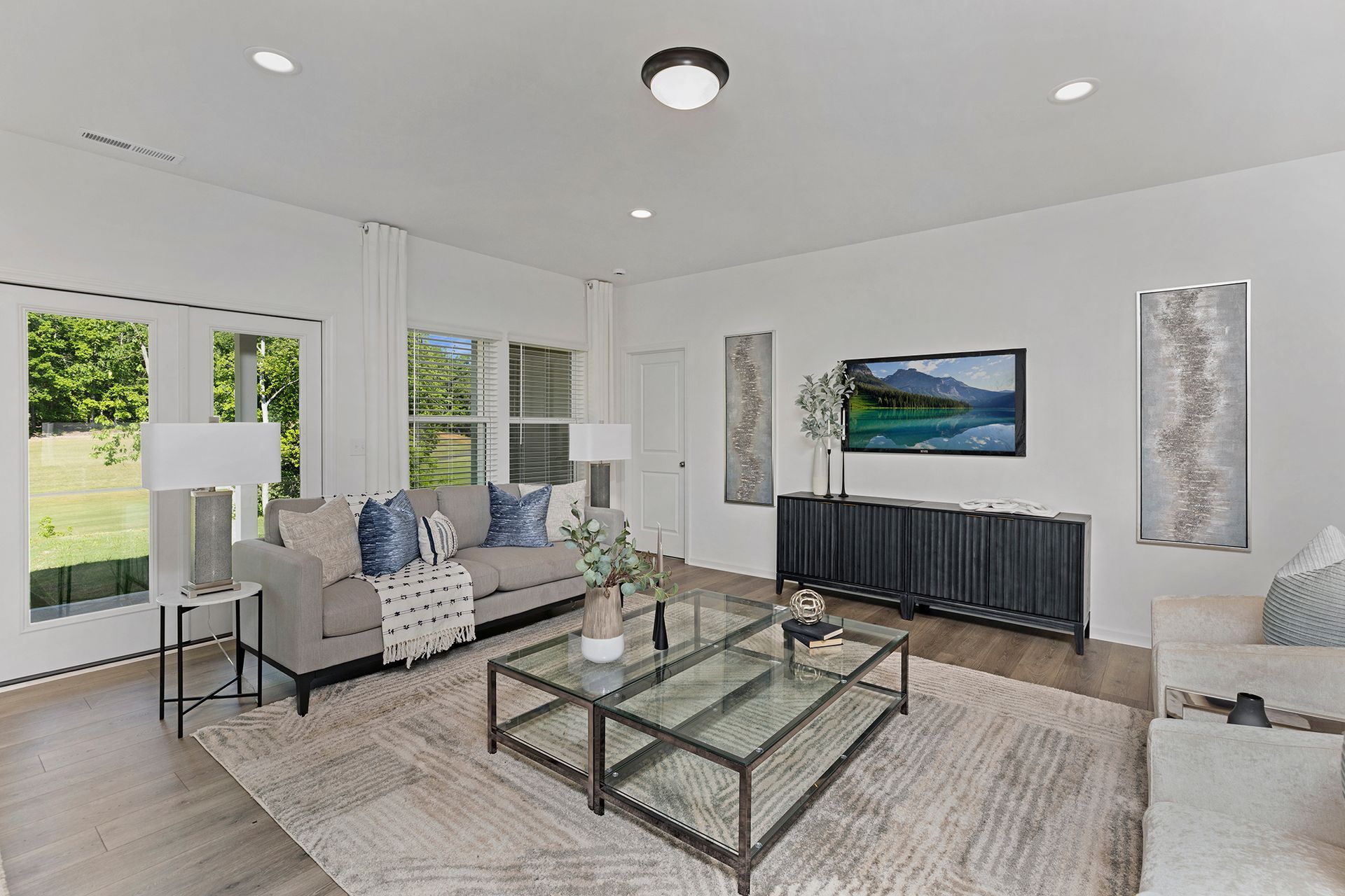 A living room with a couch , two coffee tables , and a television.