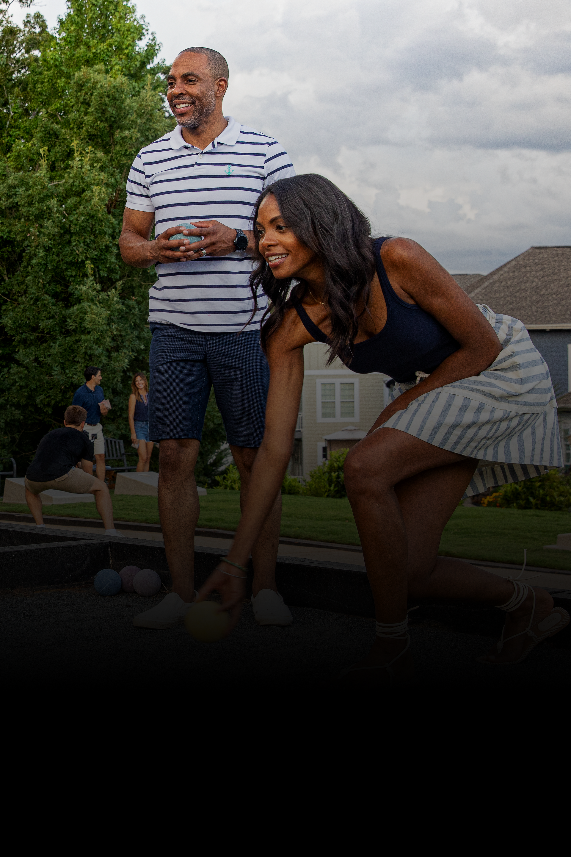 A man and a woman are standing next to each other on a sidewalk.