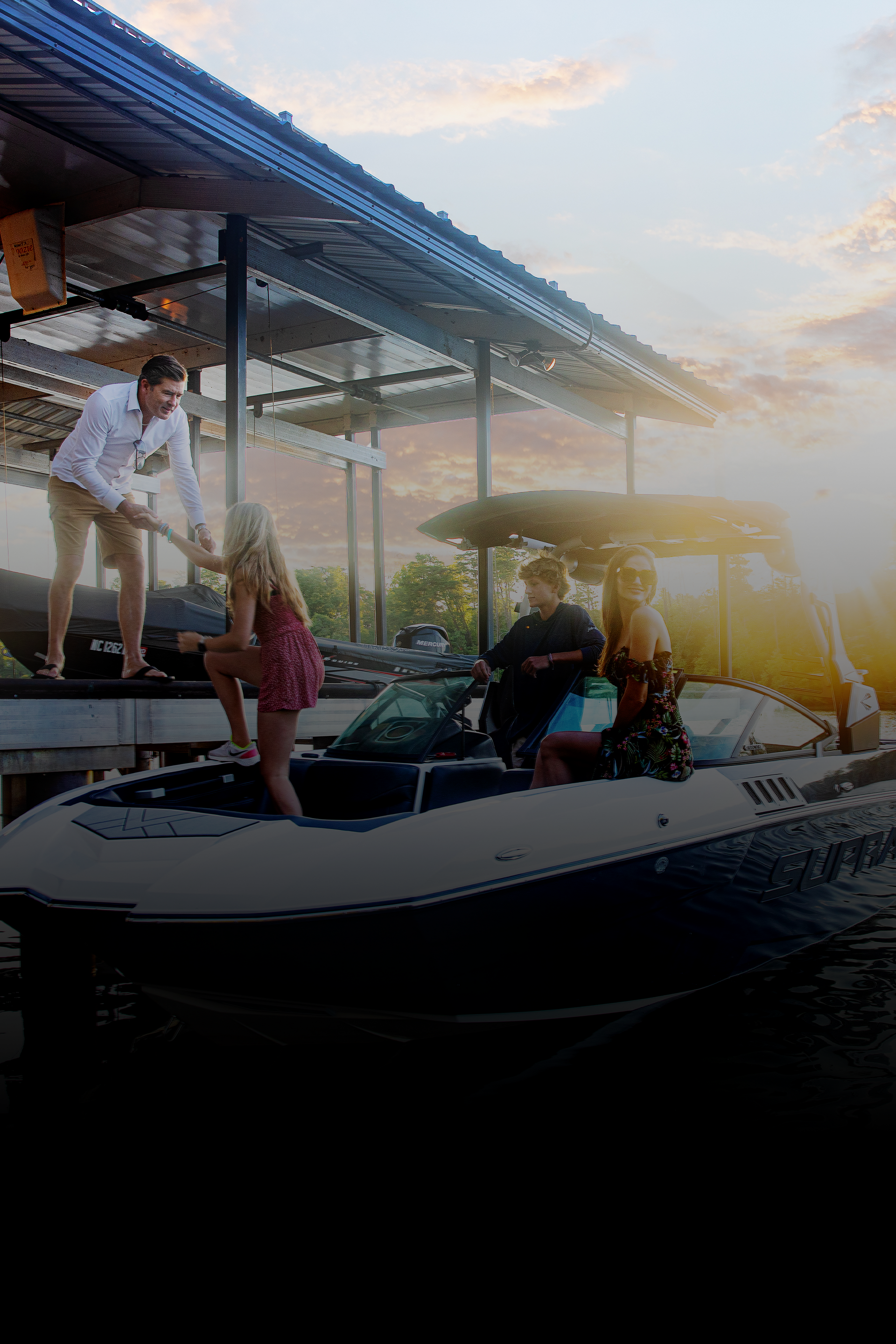 A group of people are standing on a dock next to a boat.