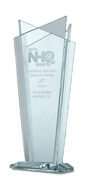 a clear glass trophy that says nhq awards on it