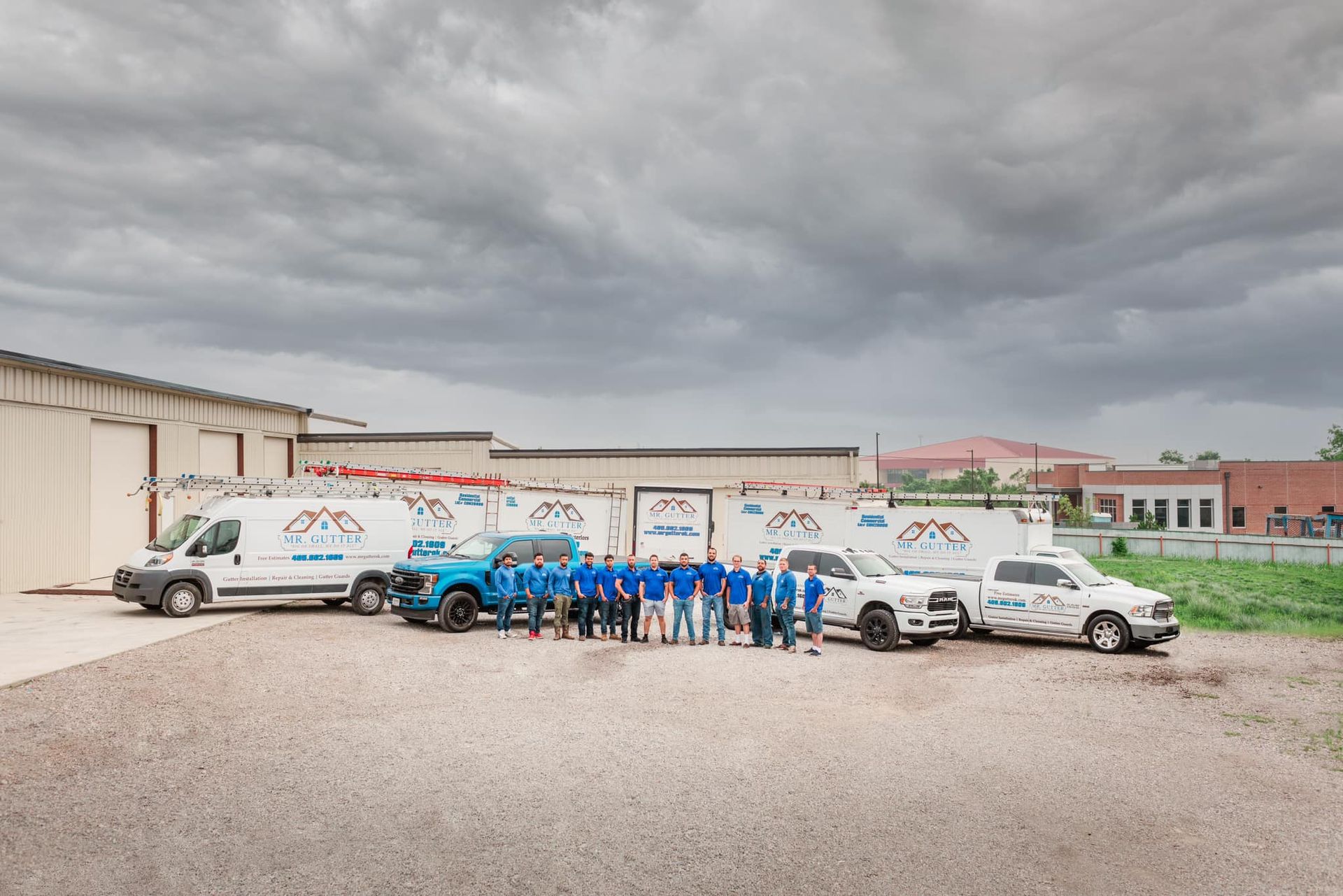 A group of people standing in front of a row of trucks.